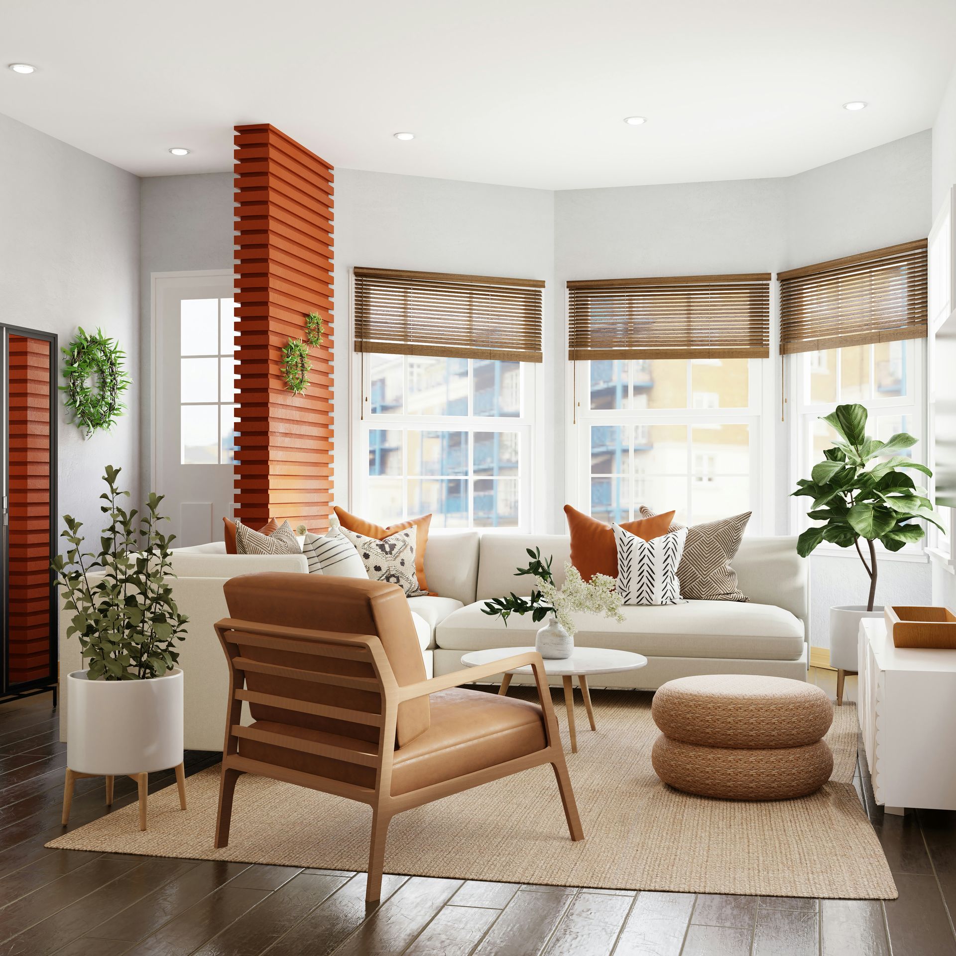 A living room with a white sectional sofa, leather armchair, and potted plants